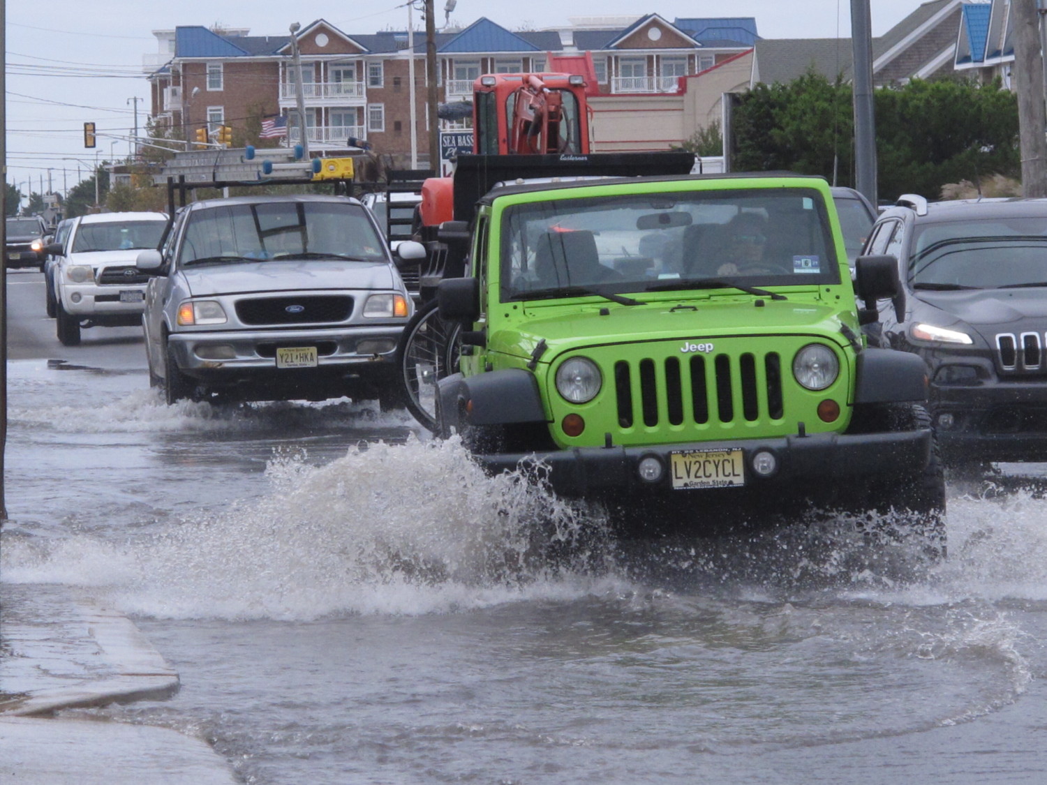 Jeep drives on flooded road near coast in New Jersey