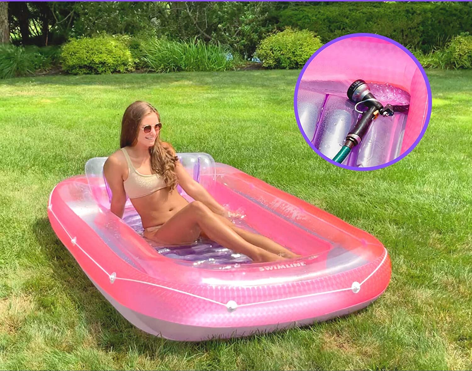 Woman sits in sunbathing tub in pink on lawn