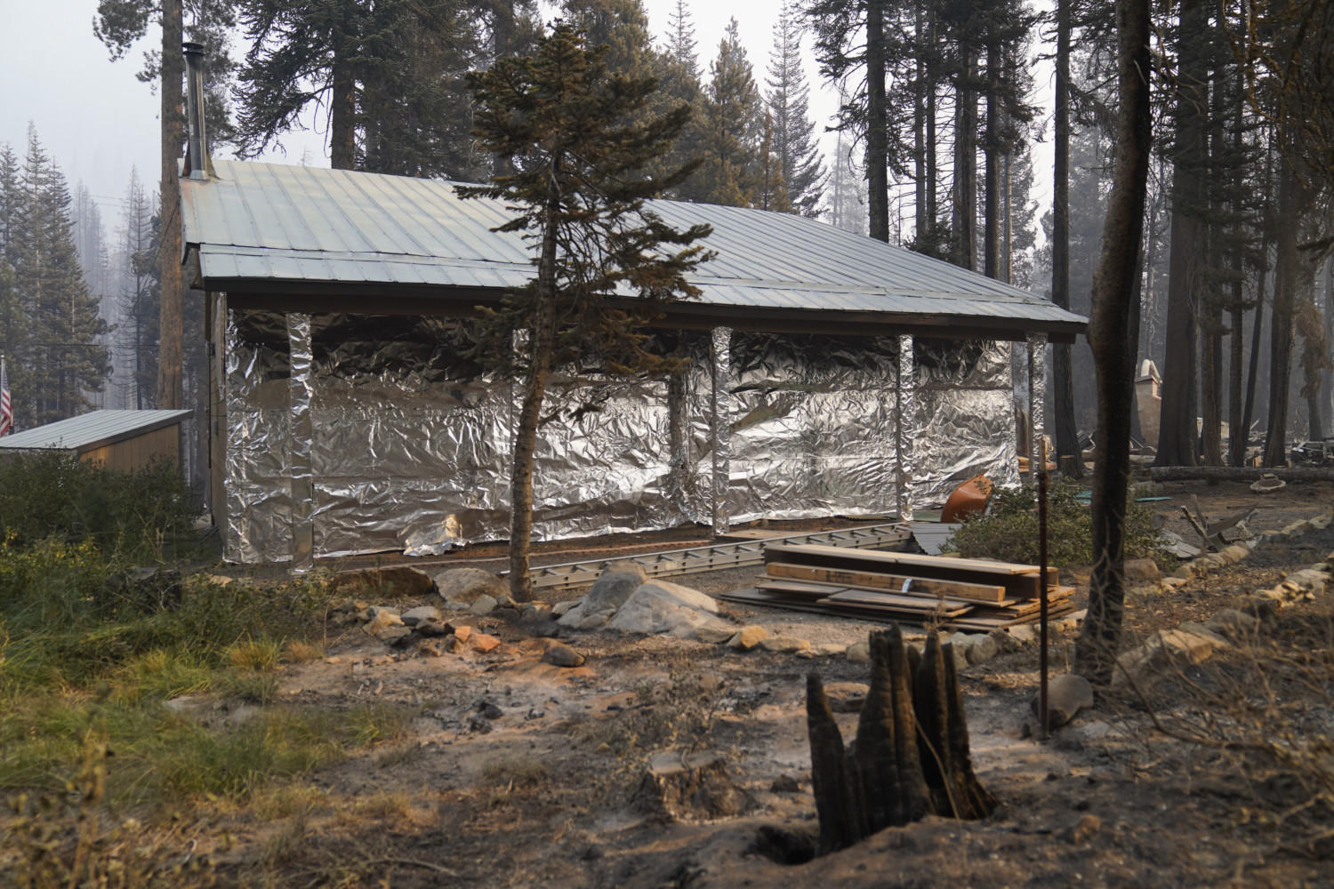 Cabin wrapped in heat-resistant aluminum for wildfires in Twin Bridges, Calif.