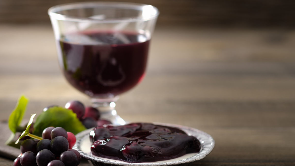 Glass of wine alongside jam