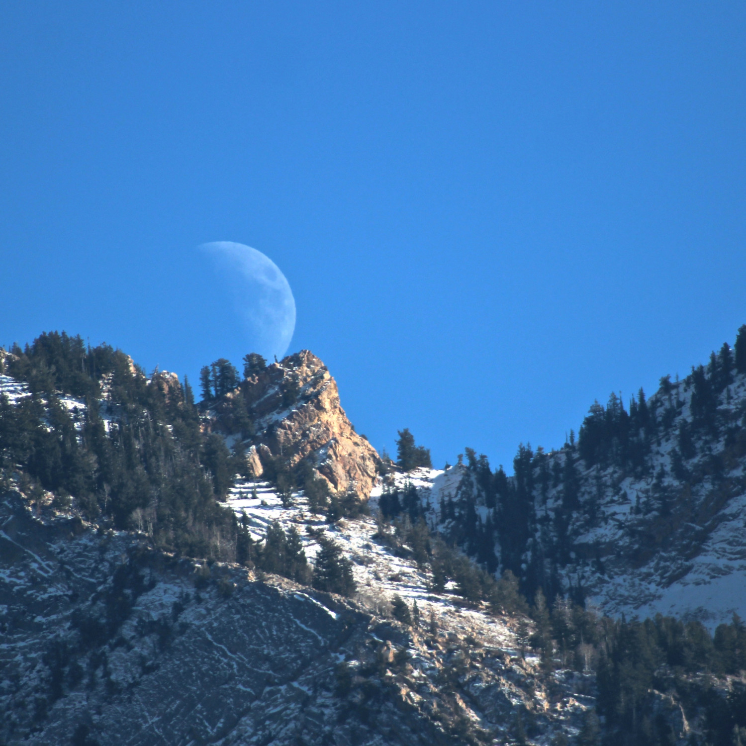 Waxing Moon rises in Wasatch Mountains, Utah.