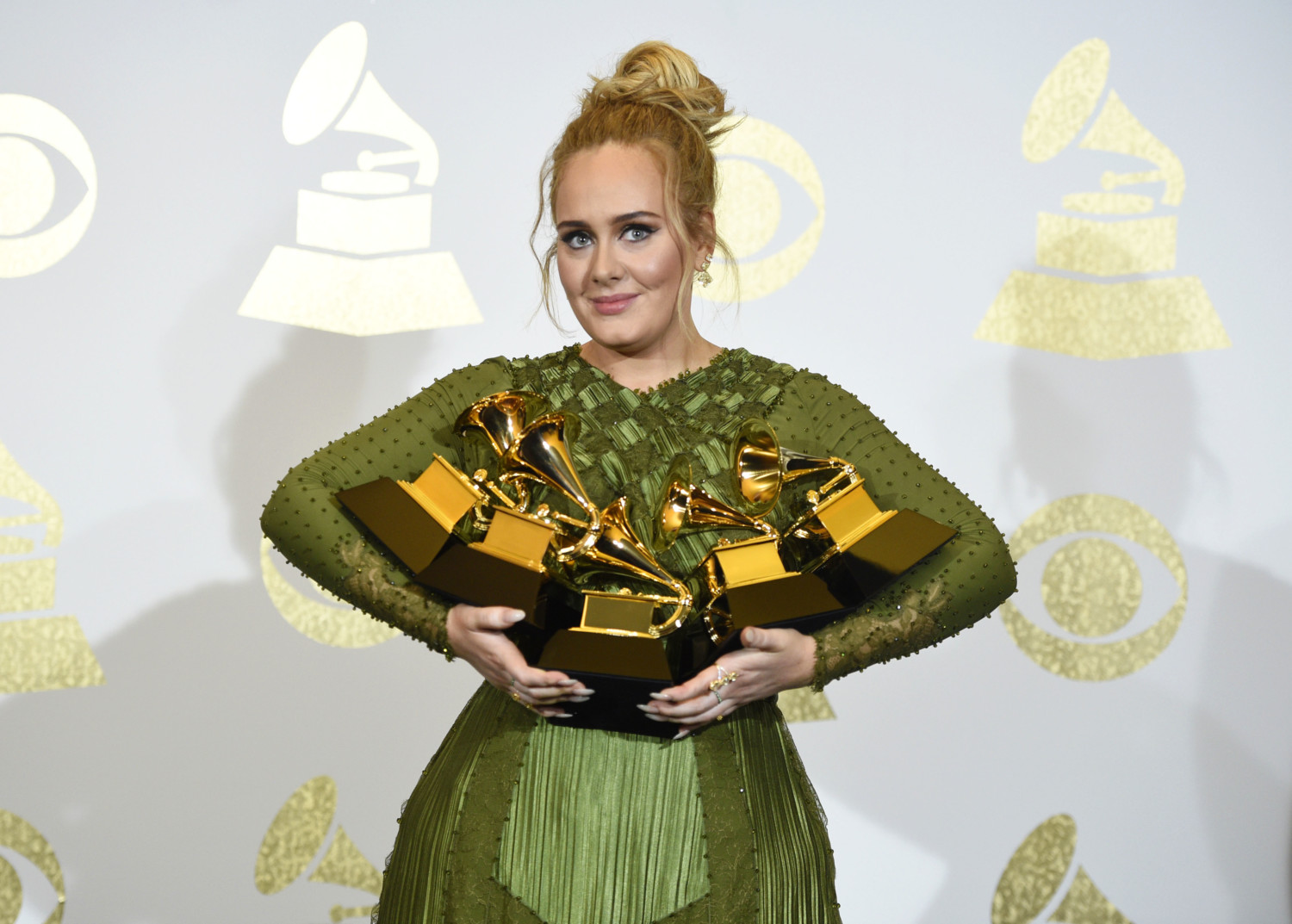 Adele holds her Grammy awards