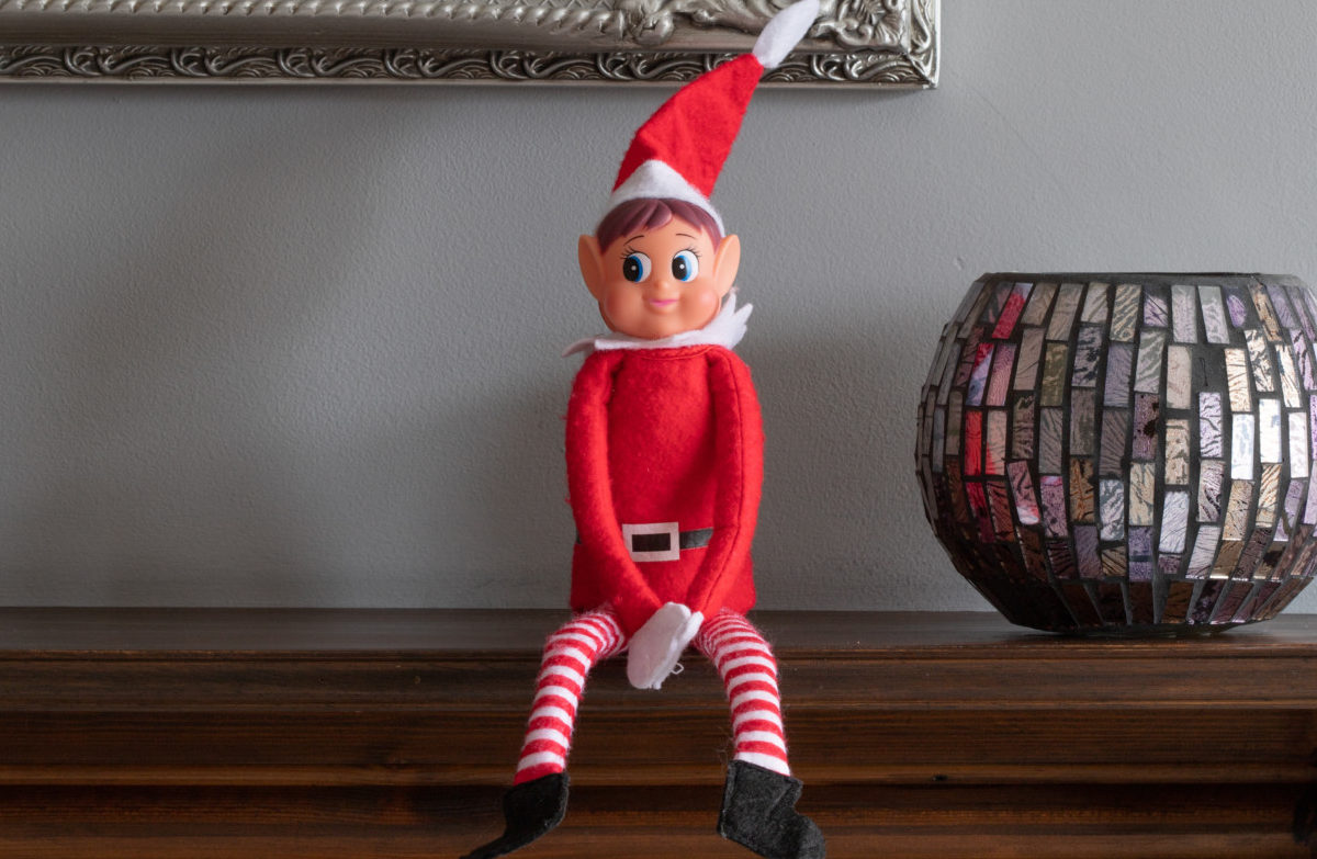 Elf on the Shelf holiday elf sitting on mantle