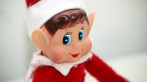 Elf on the Shelf smiles in a close up