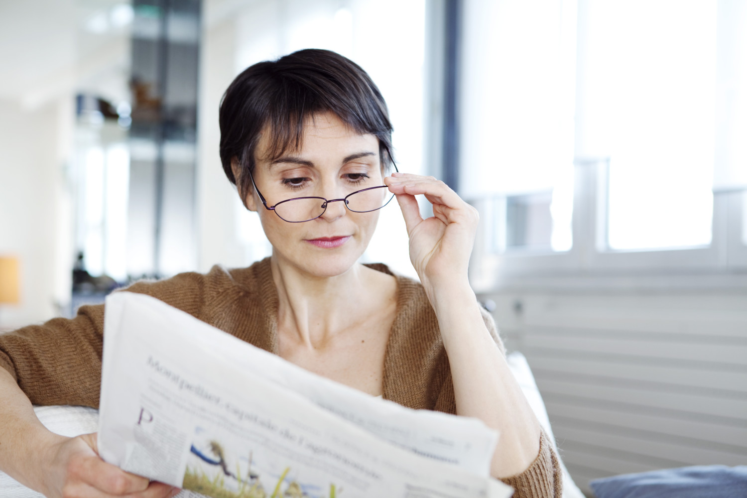 Woman using reading glasses to read