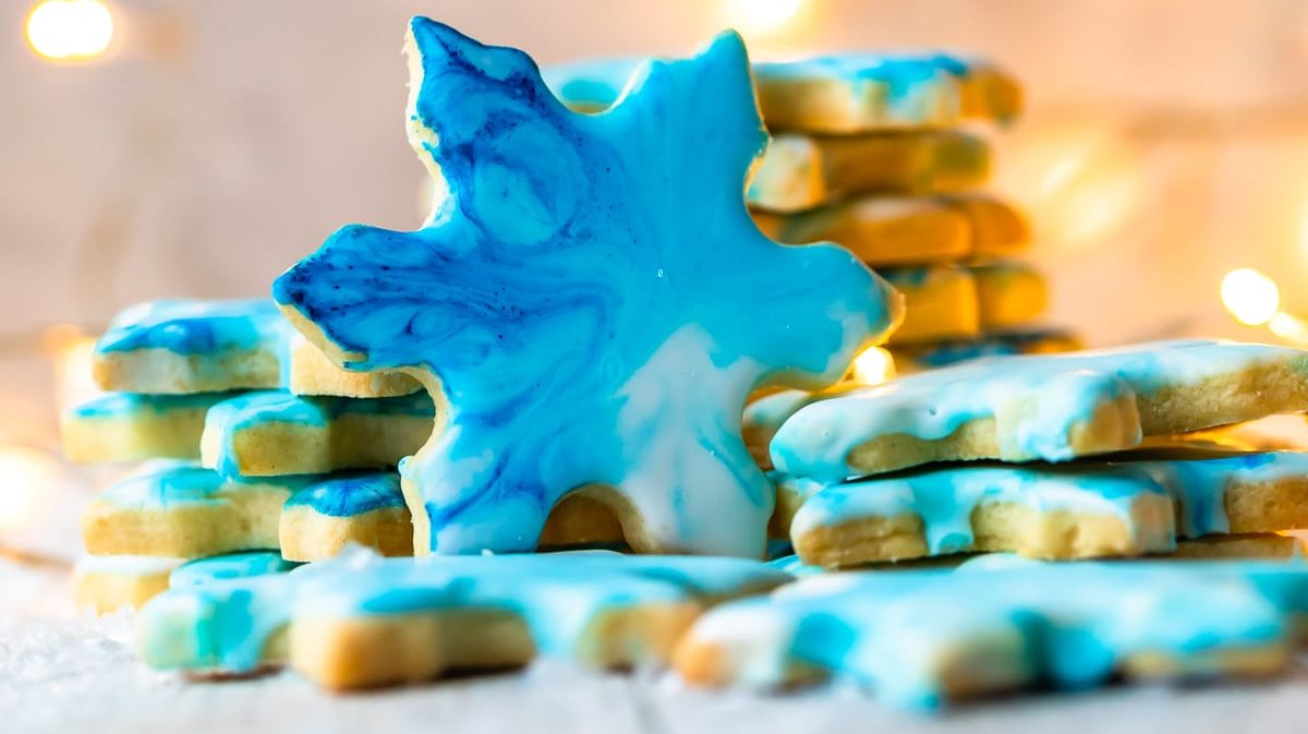 Snowflake shaped cookie with marbled blue icing
