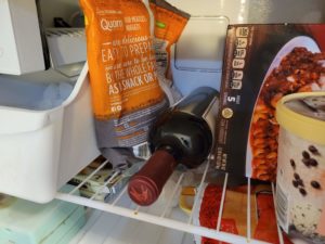 A bottle of red wine in a freezer