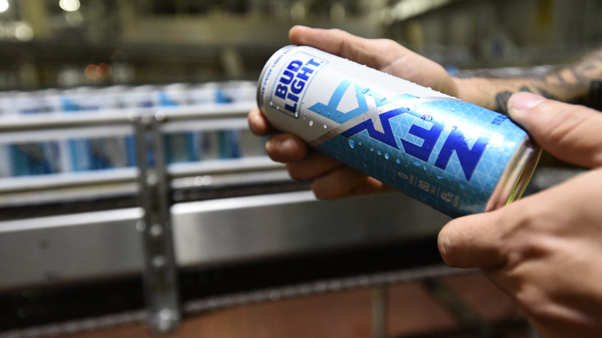Hands hold a can of Bud Light Next. It's the brand's first no-carb beer.