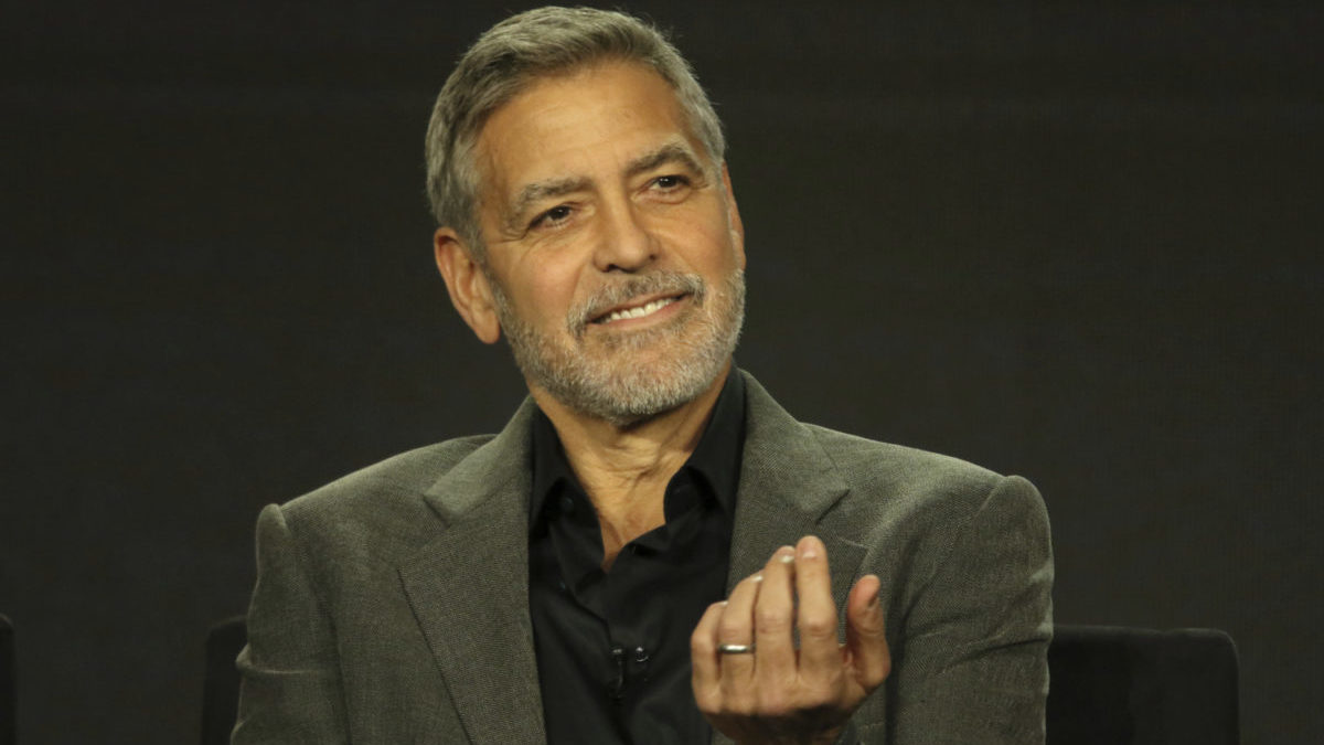 George Clooney smiles in 2019 during a panel discussion.