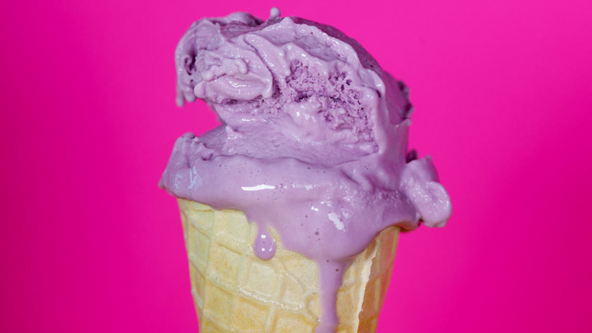 Melting purple ice cream on purple background.