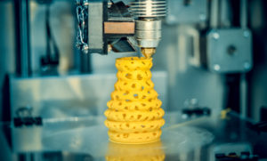3D printer printing yellow object
