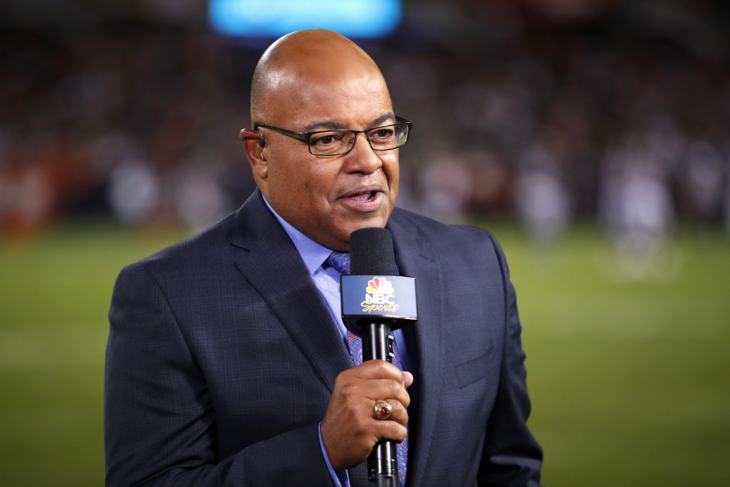 Mike Tirico broadcasts an NFL game on NBC Sports.