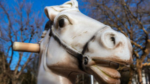 A painted rocking horse's face is shown.