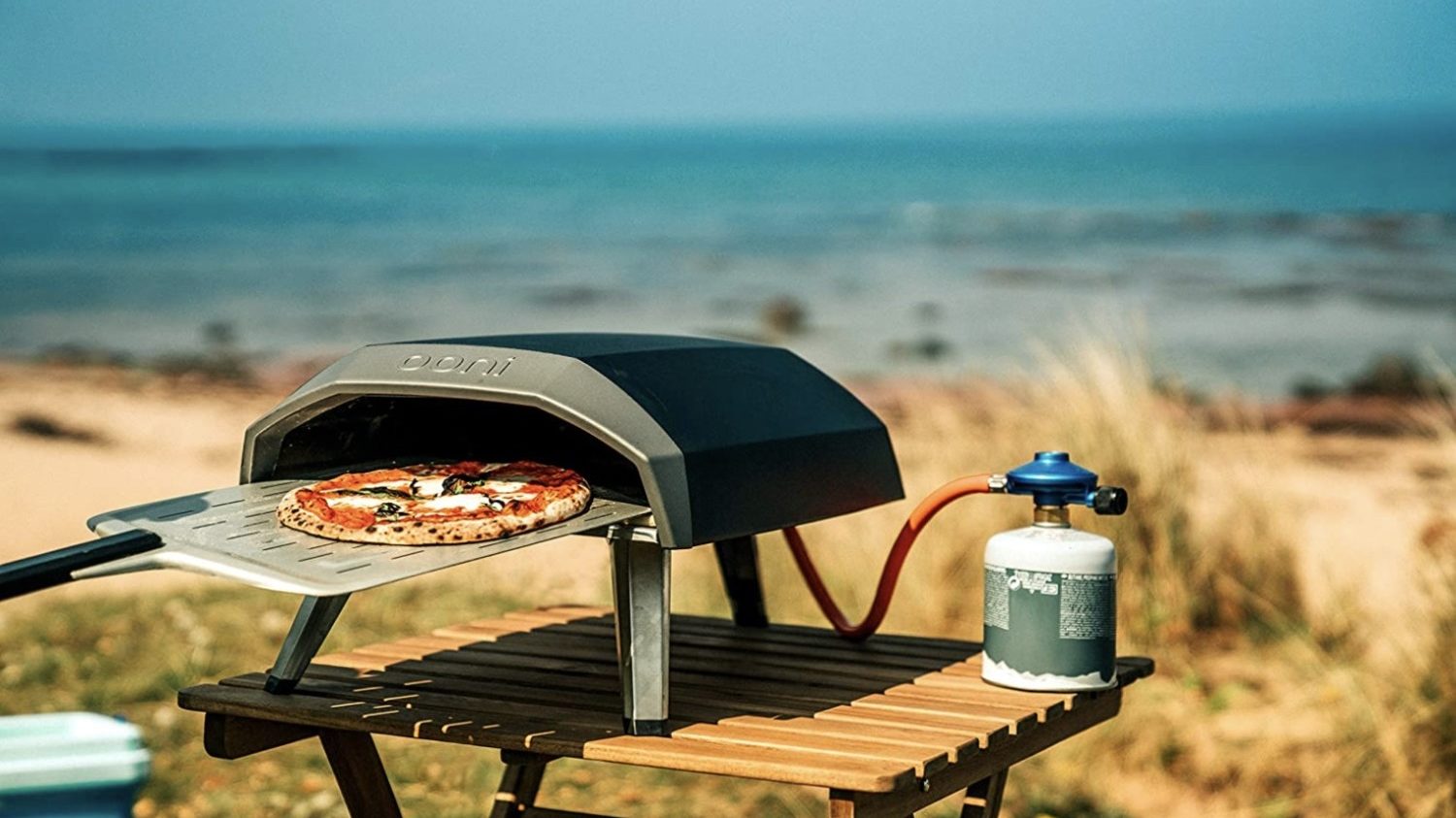 Pizza oven used outside on picnic bench