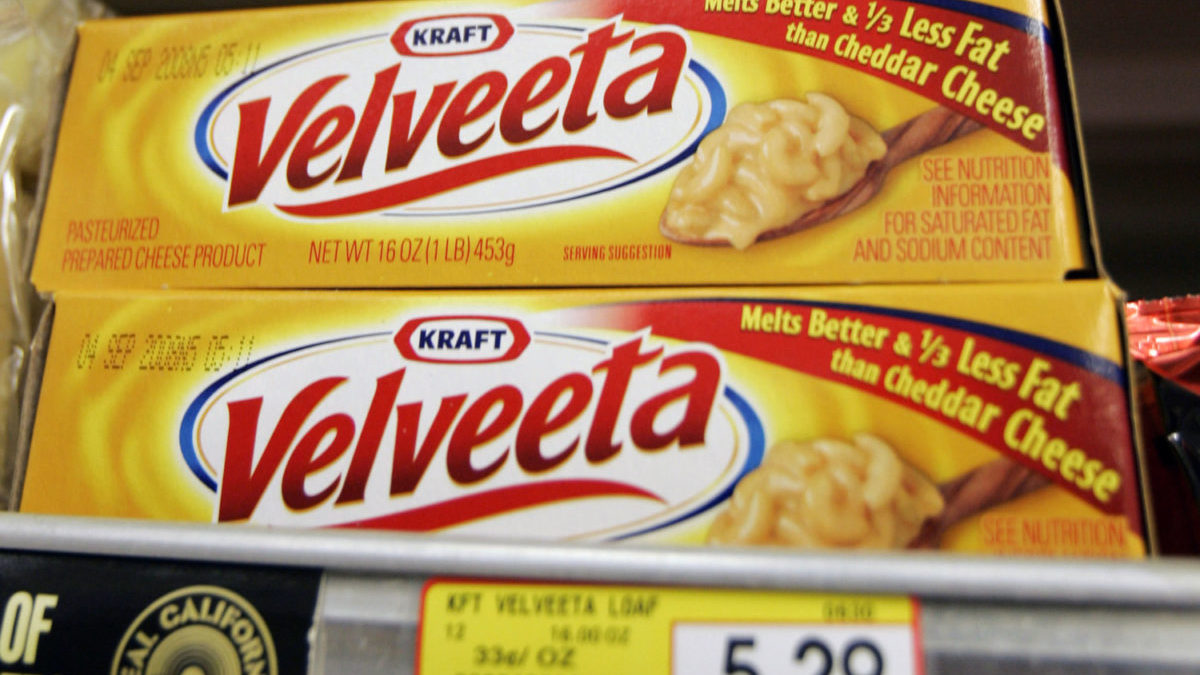 A box of Velveeta cheese is displayed on a grocery store shelf.