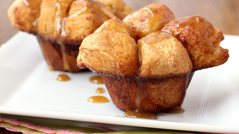 Two Monkey Bread muffins sitting on white plate
