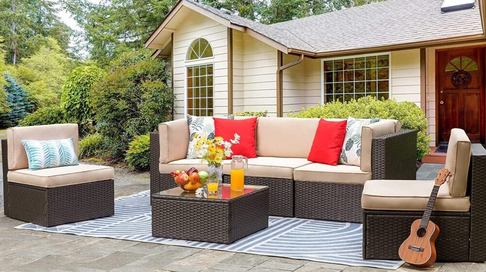 outdoor furniture sets - large outdoor couch surrounded by two smaller ones and a square center table
