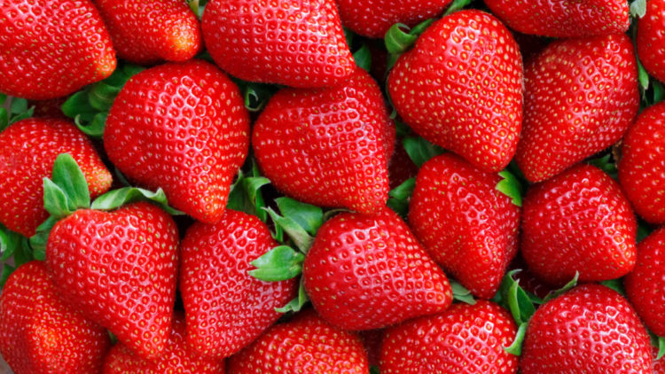 Red strawberries piled up together.
