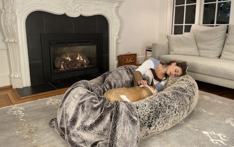 Woman and dog sleep in Plufl human dog bed