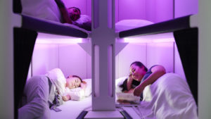 Passengers rest in Air New Zealand's Skynest bunk beds in economy class.