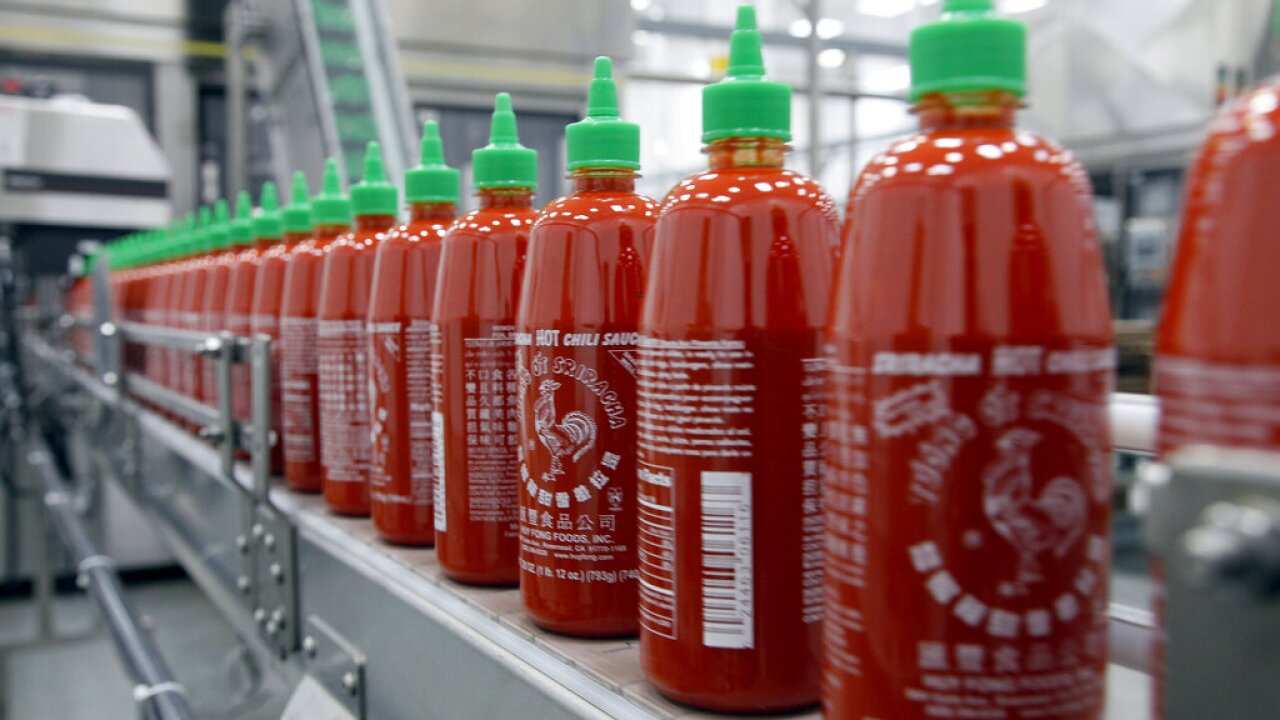 Sriracha hot sauce bottles on production line