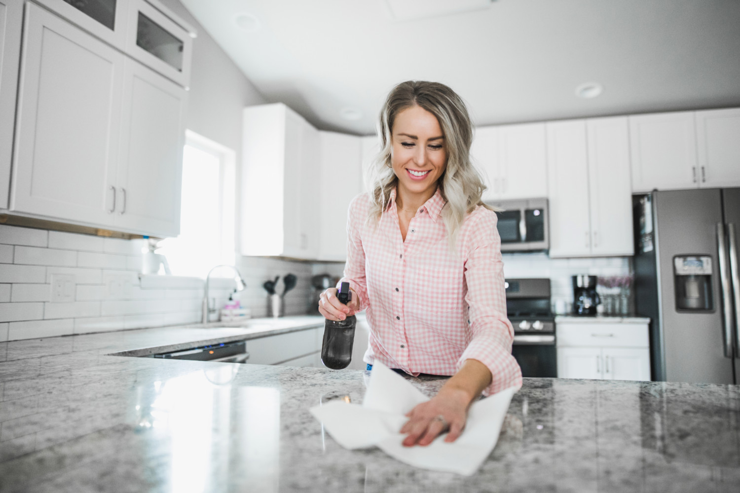 wiping her counters with natural disinfectant
