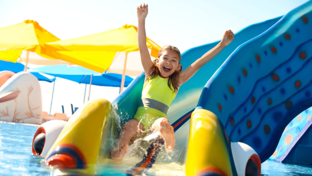 A girl rides a waterslide at a family-friendly hotel.