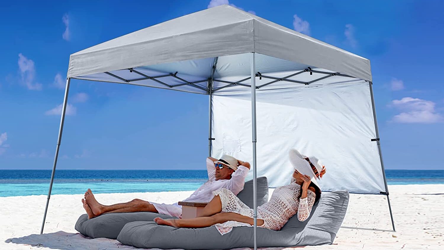 beach tent with couple underneath in lounge chairs