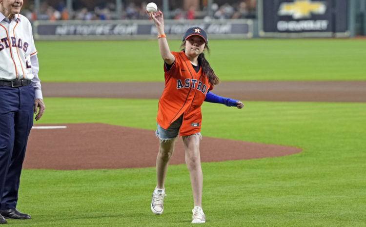 Mayah Zamora, a survivor of the school shooting at Robb Elementary in Uvalde, Texas, throws out a ceremonial first pitch before a baseball game between the Minnesota Twins and Houston Astros Tuesday, Aug. 23, 2022, in Houston.