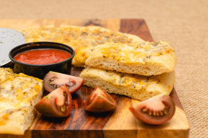 Cheesy bread with marinara and tomatoes
