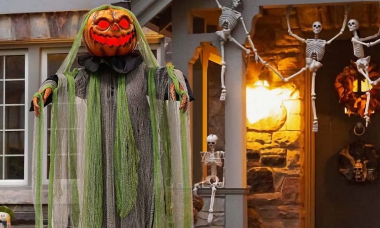 A Halloween animatronic called the Root of Evil stands on a person's porch.