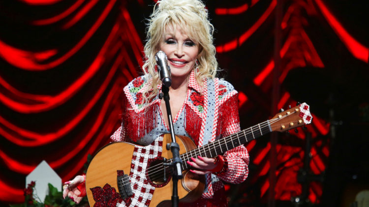 Dolly Parton performs on stage.