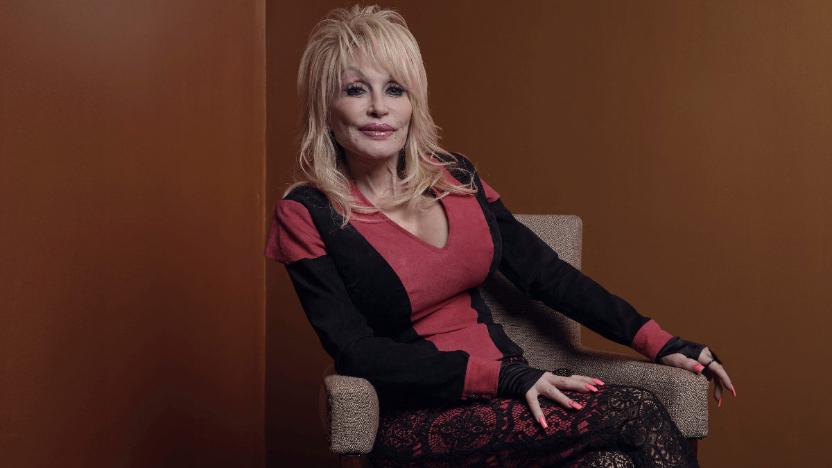 Dolly Parton sits posing for a portrait.