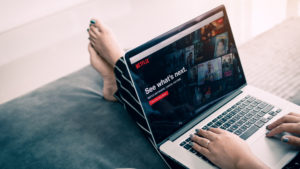 Netflix user watches on laptop