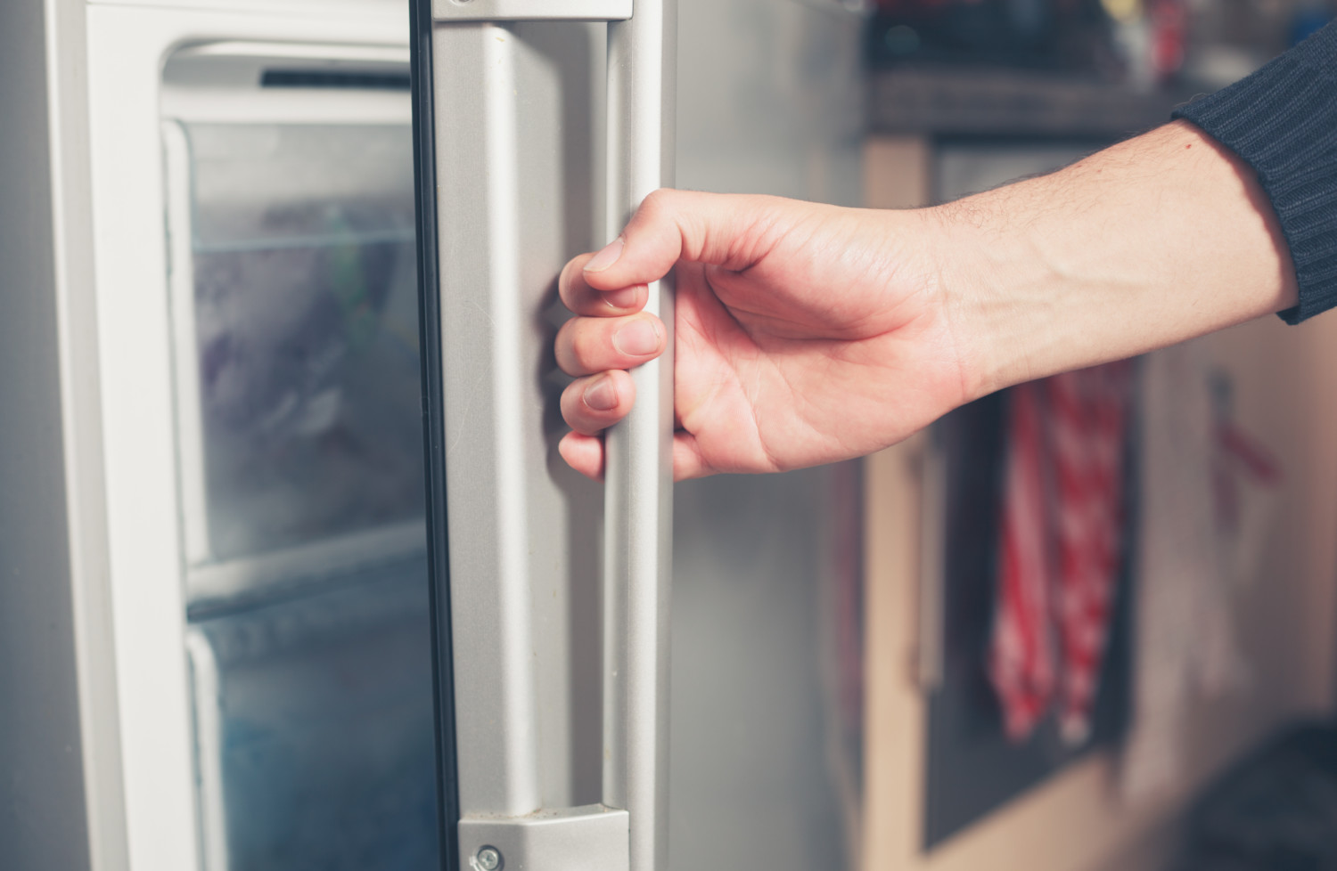 man opening freezer door