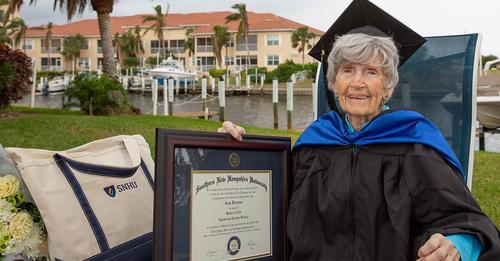 Joan Donovan holds her master's diploma