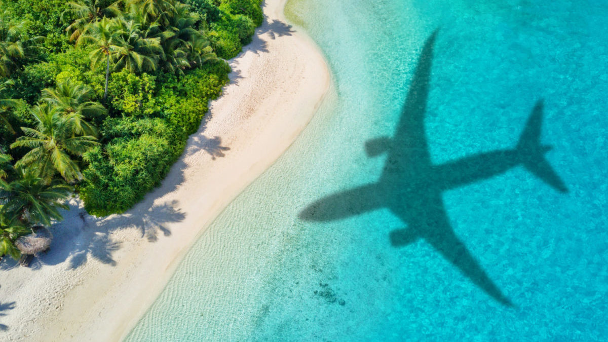 Airplane shadow on tropical beach