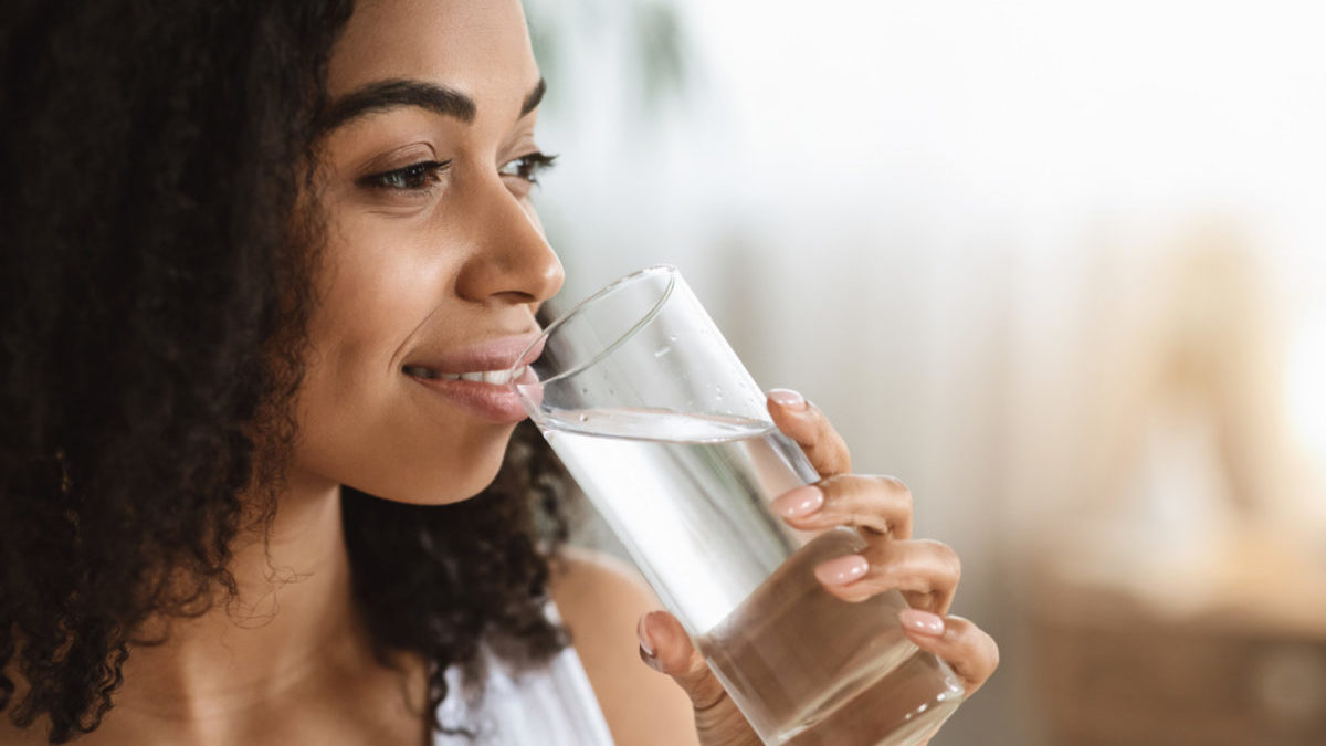 Healthy Liquid. Smiling Black Woman Drinking Water