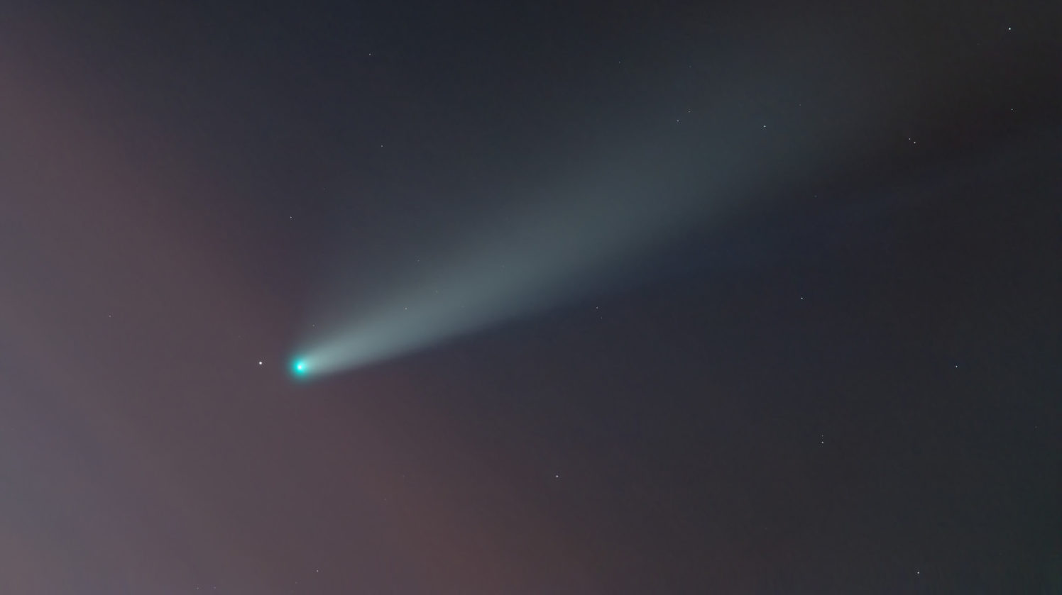 Green comet C in night sky