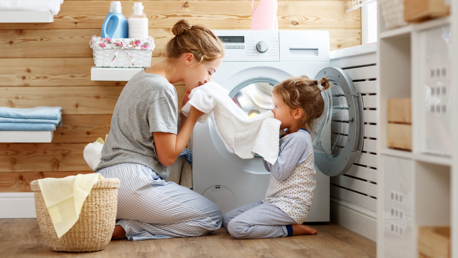 Mom and daughter pull whites from laundry