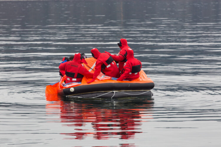 Rescuers float on life raft