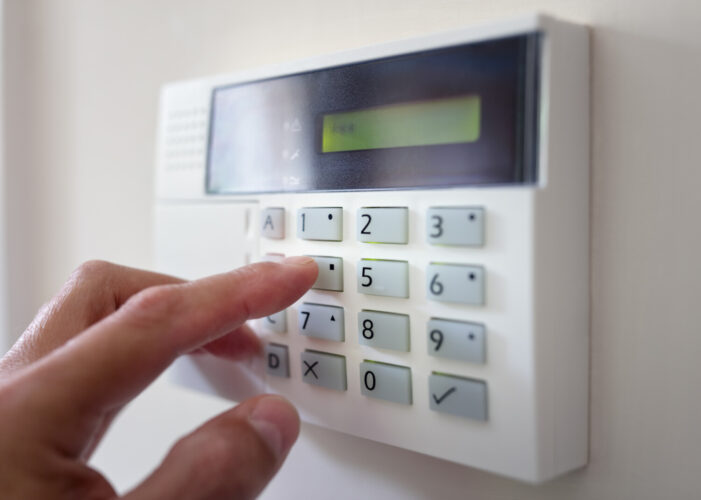 Homeowner uses keypad on home security system