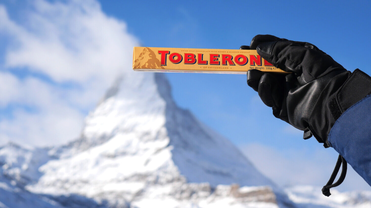 Toblerone bar held in front of Matterhorn