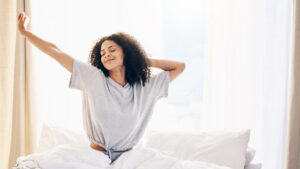 Woman wakes up refreshed in bed