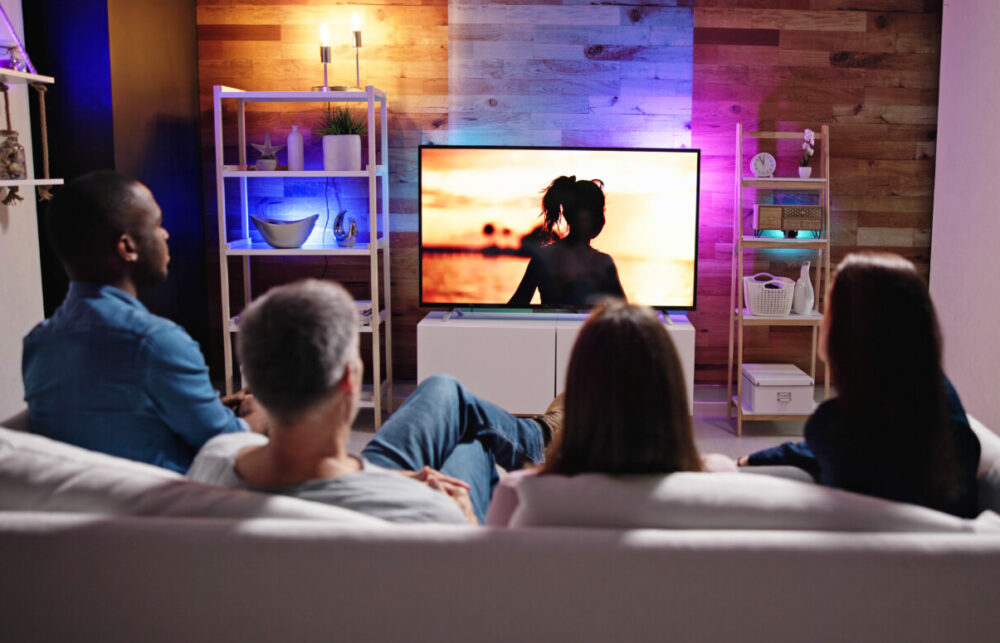 two couples watch TV