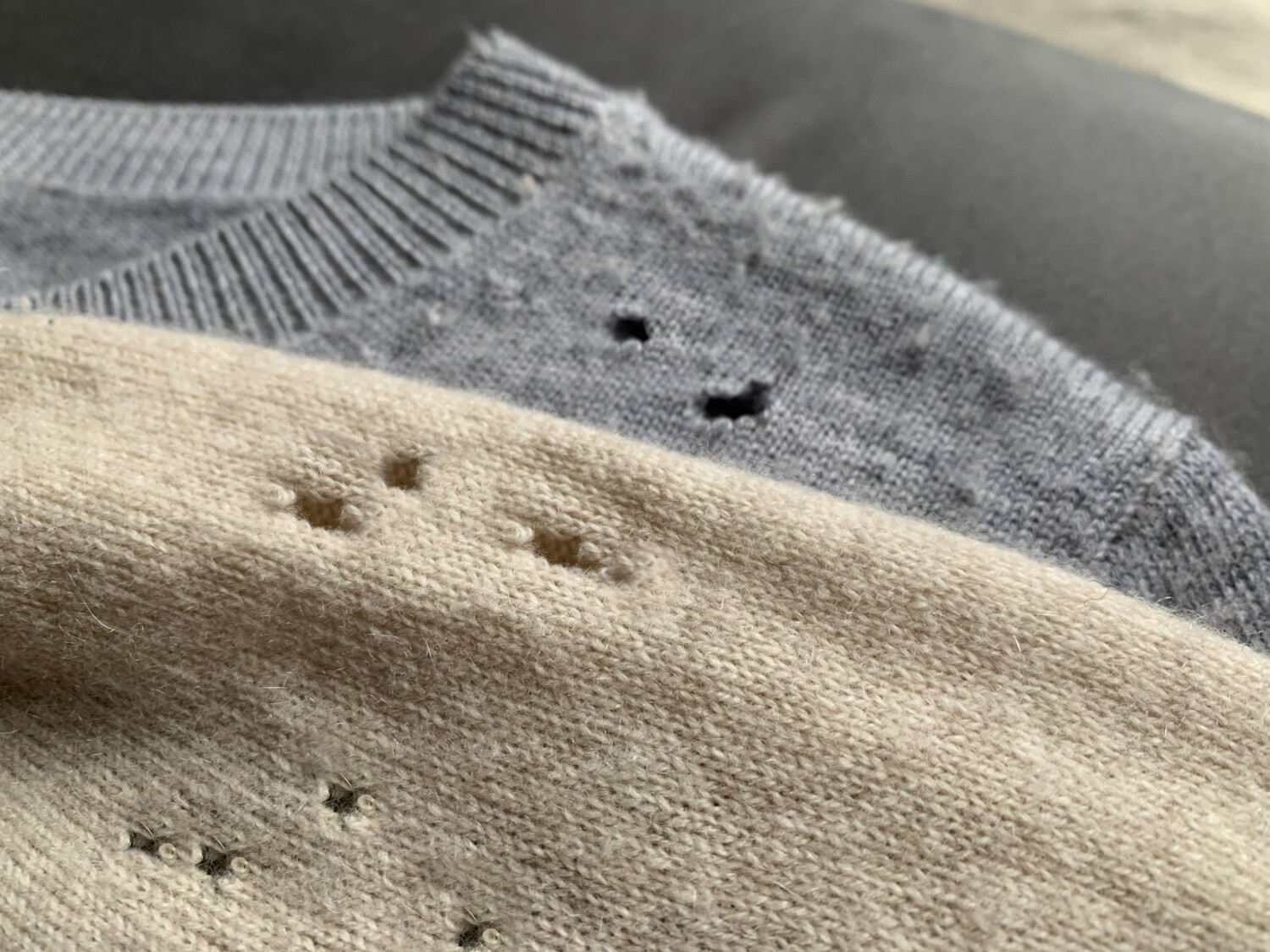 two sweaters with moth holes