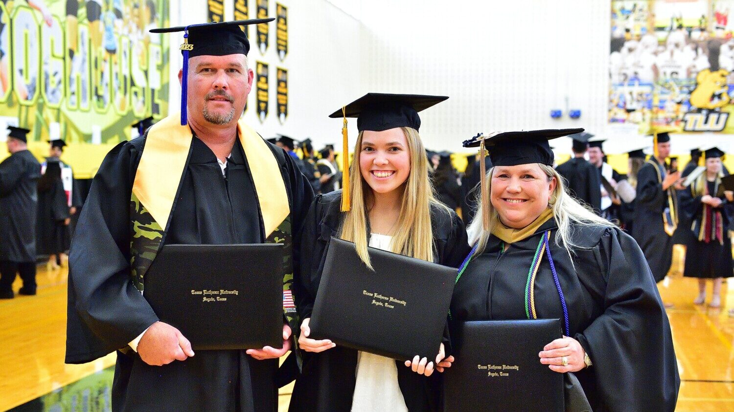 Adams family holds diplomas at graduation