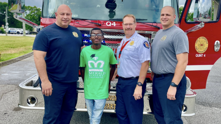 O'Tavais "OT" Harris and firefighters who assisted his birth