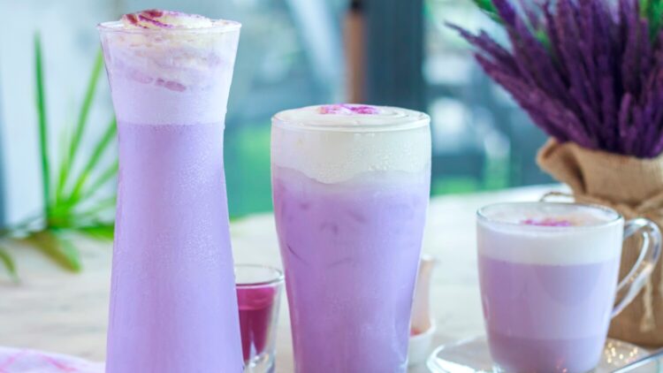 Purple milkshakes lined up on table