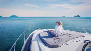 casually dressed woman sitting on a yacht on the sea